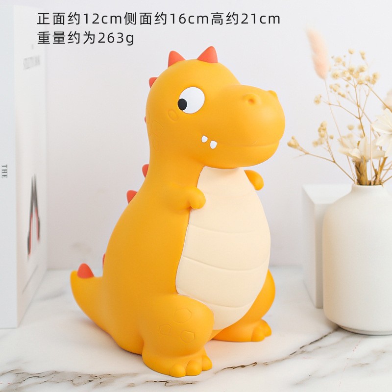 La decoración del hogar de la alcancía de los niños lindos de dibujos animados transfronterizos puede entrar y salir de la alcancía de dinosaurio resistente a la caída