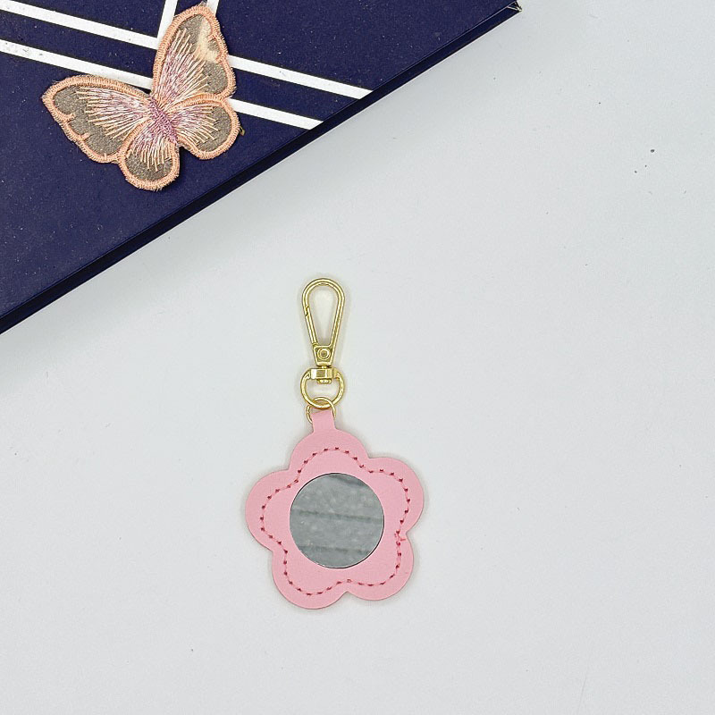 Flor espejo llavero cuero transfronterizo regalo colgante joyería creativo mini lápiz labial almacenamiento llavero colgante