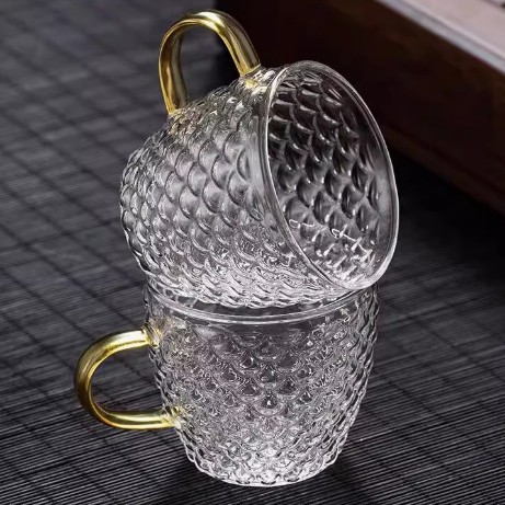 Venta directa de fábrica Tetera de vidrio con alto contenido de borosilicato Tetera de espuma con patrón de martillo de viga de elevación de metal Tetera de vidrio de alta calidad para el hogar
