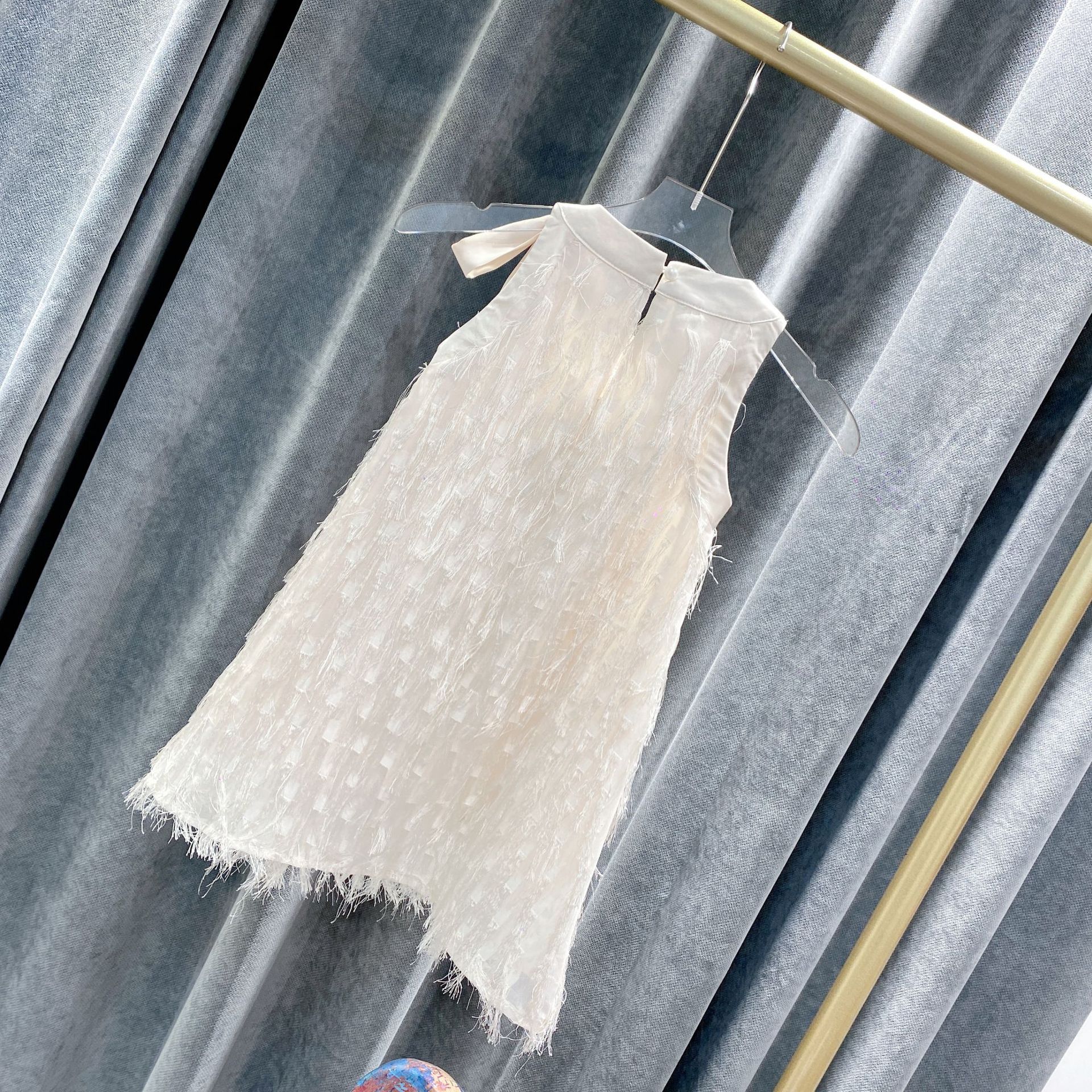 Mother and daughter in matching white fringe dresses holding flowers