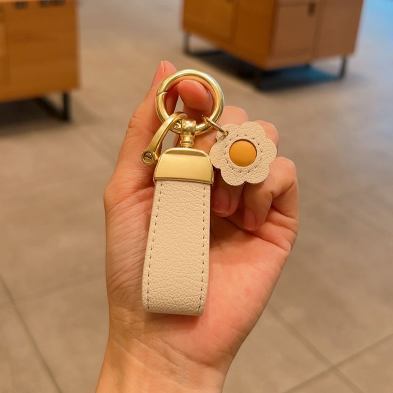 Estilo francés de alta gama de cuero fresco cuerda coche llavero simple lindo clave colgante Pequeño Libro Rojo mismo estilo girasol