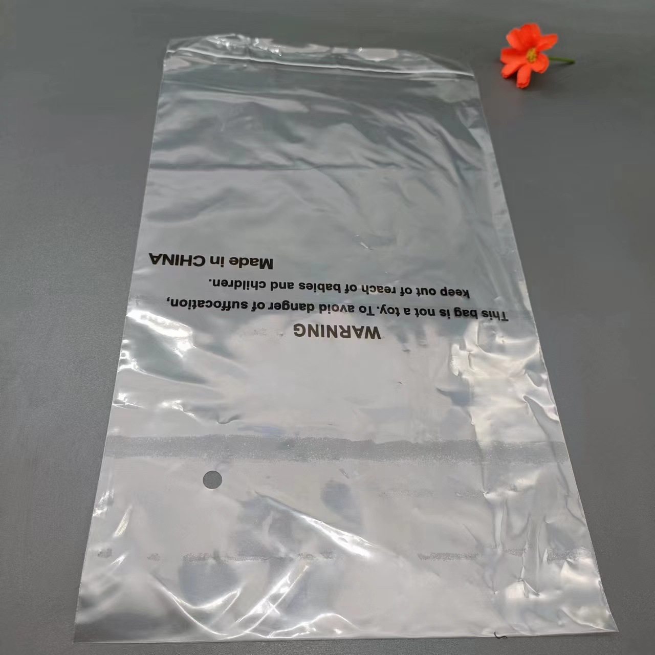 工厂直销PE袋现货外贸通用警示语服装包装袋PE透明塑料自粘包装袋