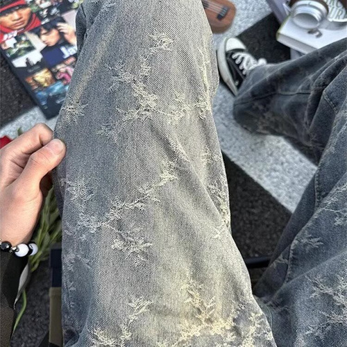 American-style high-street vibe camo tie-dye denim jeans for men: loose-fit, casual, washed-out look with dramatic ink-splashed, vintage-inspired drop-crotch design.