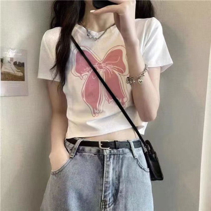 Camisas de mangas cortas americanas de alta calle caliente para mujeres 2026 verano delgado cintura alta ombligo corto de moda impresa blusa