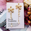 Silver needle with bow, long elegant fashionable earrings from pearl with tassels, diamond encrusted, silver 925 sample