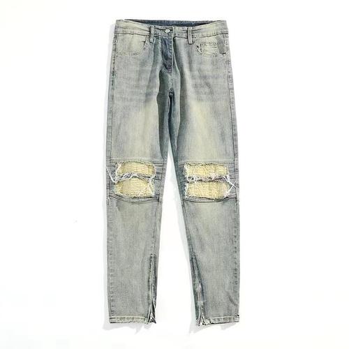 Euro-American trendy high-street light-blue distressed denim jeans for men: vintage-style, slim-fit, tapered legs, with zip-up cuffs—versatile and easy-to-match trousers