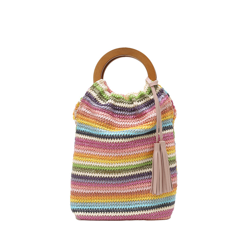 Versión coreana del bolso de cubo de nicho 2025 verano nuevo bolso femenino a rayas bolso de color en contraste bolso tejido con borlas de paja marea