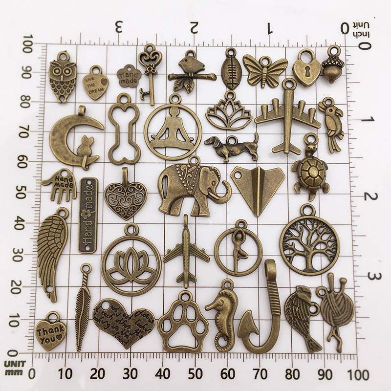 100個の混合レトロなイヤリングのネックレスのアクセサリーの古い青銅の小さいペンダントのdiy材料の合金の部品は鏡にまたがります。|undefined