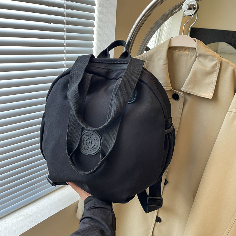 Small shoulder bag, one‑shoulder backpack style, round design, black