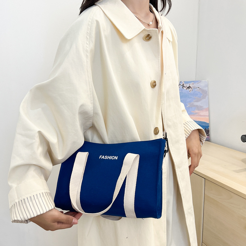 2024 nuevo simple japonés blanco y negro bolso de tela de gran capacidad para estudiantes de clase de viaje mochila de hombro