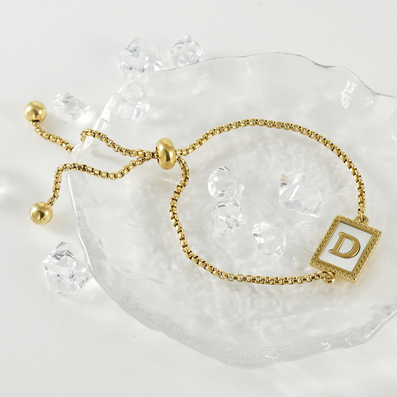 Nuevo europeo y americano transfronterizo de acero inoxidable 26 letras inglesas Shell pulsera personalidad todo partido titanio acero 18K cremallera