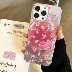 キラキラ光る銀色の底のピンクの蝶結びの渦はリンゴの16promaxの携帯電話のiphone 15/14に適用します。