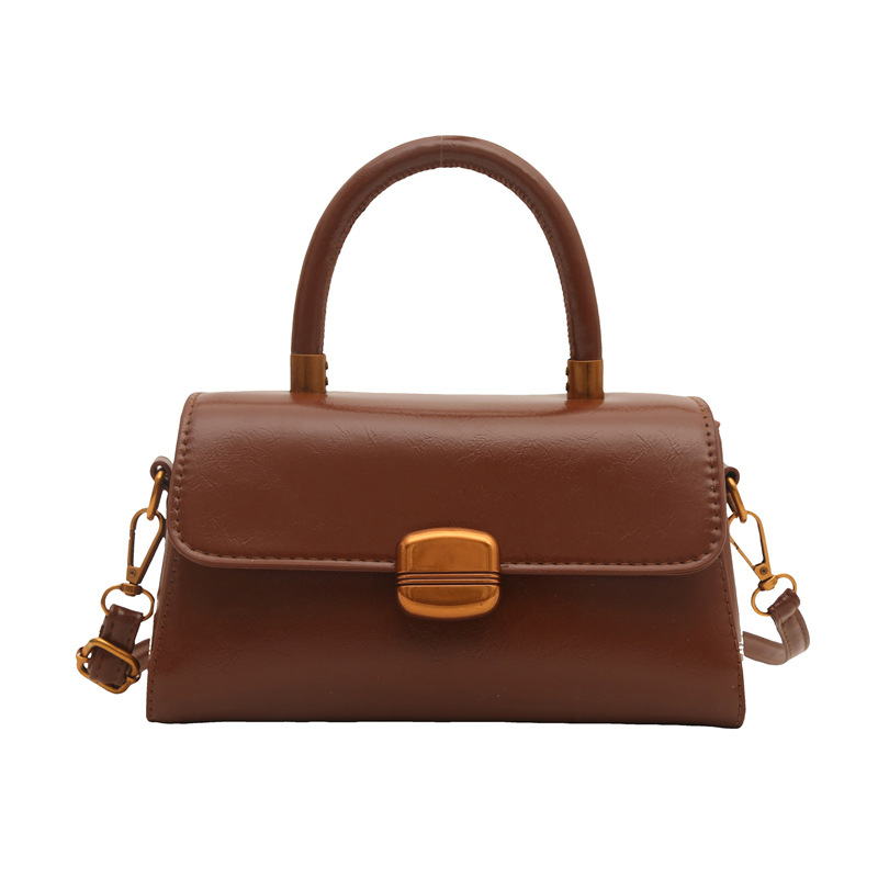 Nicho de diseño coreano bolso de mano 2025 primavera nuevo estilo simple de moda con cierre de flip de hombro monocolor bolso de mochila