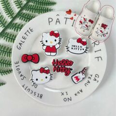 赤い本の同じ靴の花の穴の靴のかわいい立体は靴のボタンの漫画の部品の牛乳の猫のdiyの装飾を飾ります。