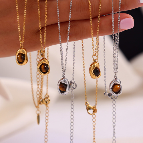Vintage English-style niche accessory with an indented elliptical pendant featuring tiger's eye stone, designed titanium steel jewelry set