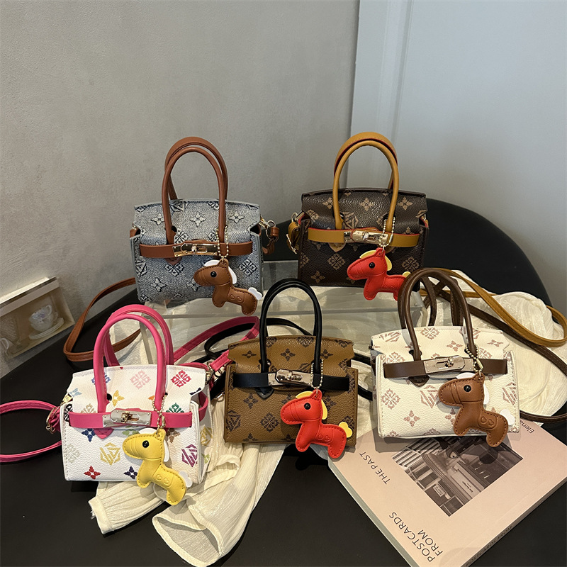 Impresión de moda coreana bolsos de chicas lindos colgantes de pony bolsos de hombro de aire extranjero mini bolsos de niños