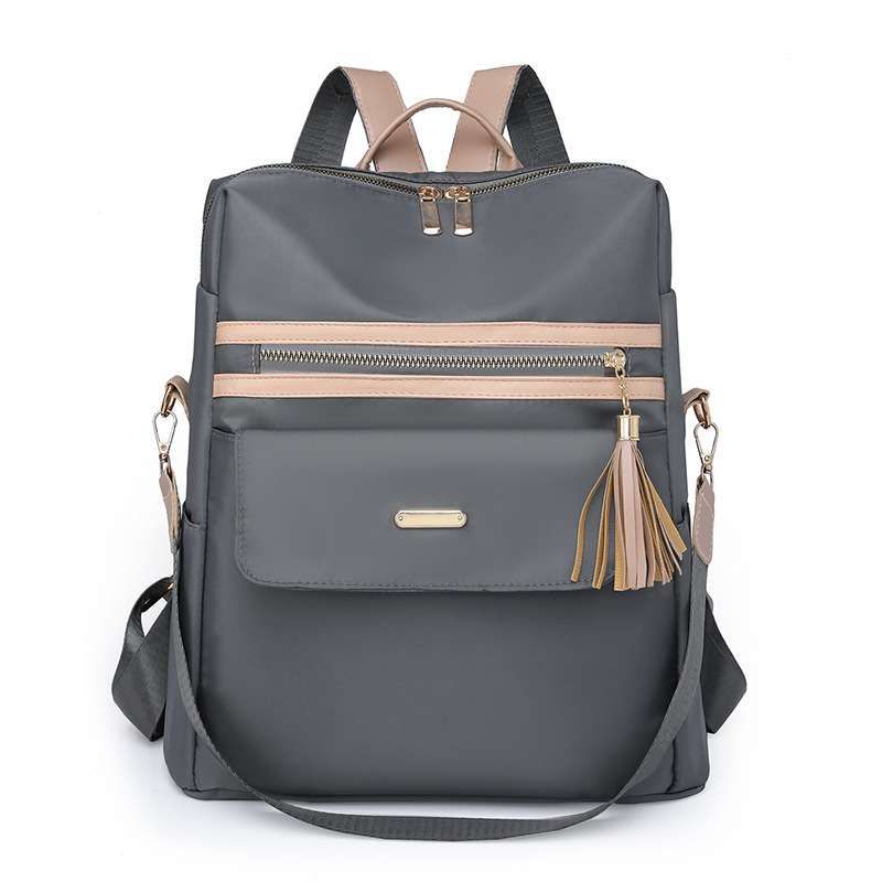 2023 nueva mochila casual para mujer nylon color contraste moda borla mochila de viaje multifuncional de doble uso al por mayor