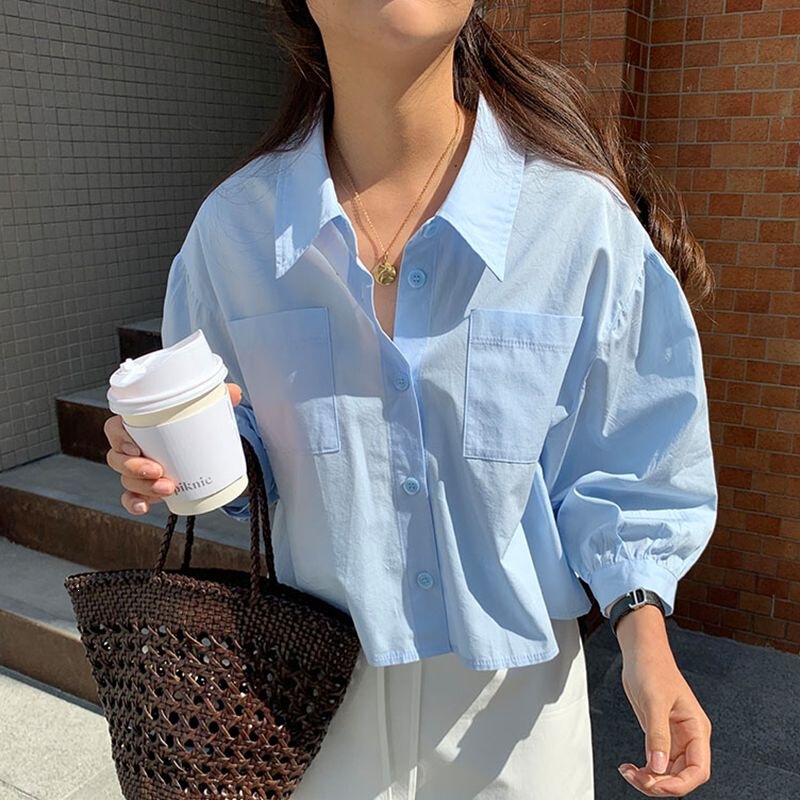 French-style versatile sky blue shirt for women, flattering and brightening, with a turn-down collar, single-breasted, loose fit, pockets, casual short length, and lantern sleeves