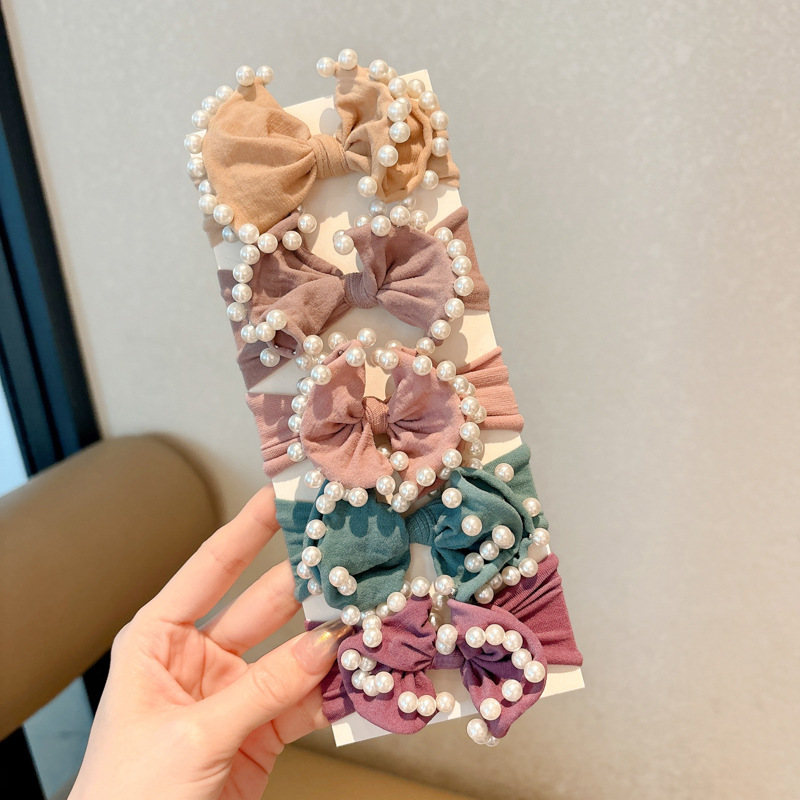 Arco de perla máscara anillo de cabello femenina baja cuerda de cabello bola adornamiento de cabello correa de cuero cuerda de cabello al por mayor