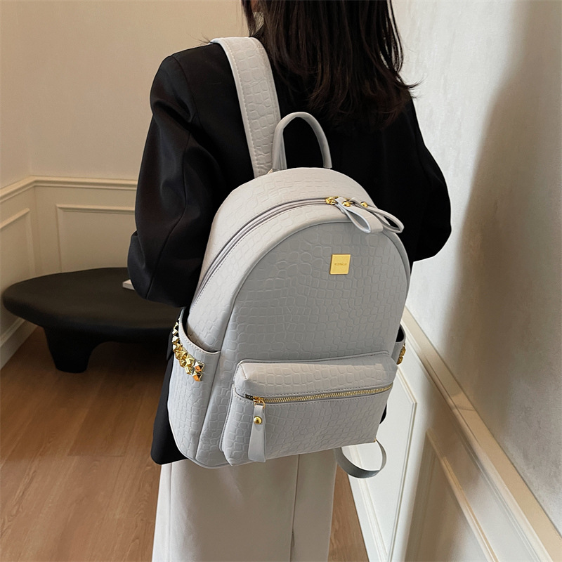 Mochila de viajes de gran capacidad de aire extranjero 2025 nueva mochila de mujer transfronteriza popular mochila de estudiantes universitarios con patrón de piedra