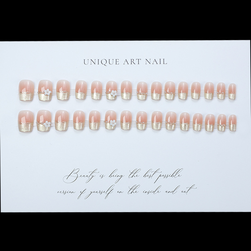 Uñas postizas francesas con diseño floral dorado, estilo ojo de gato, cortas y desmontables, producto de alta gama para arte de uñas 2026.