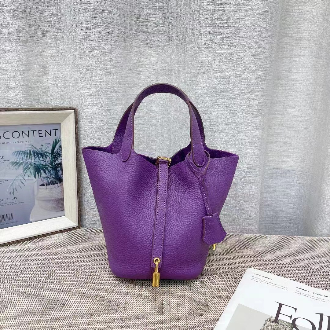 El nuevo bolso de cesta de verduras de marea de cuero togo de piel de vaca de capa superior 2025, bolso de cubo con cerradura de mano, bolso de cuero para mujer