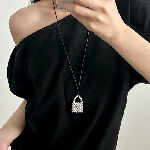 A handmade copper bead necklace with a vintage and unique design, featuring a long pendant shape inspired by Korean blogger accessories.