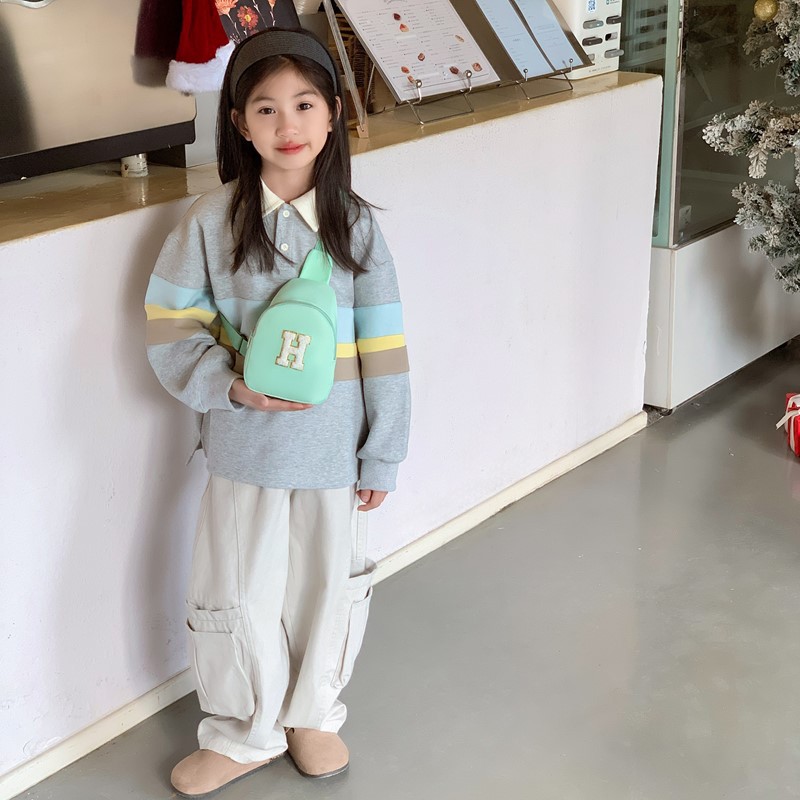 2026 nuevo bolso infantil de comercio exterior letras de moda coreana bolso de pecho para niños y niñas bolso de cinturón casual de color sólido