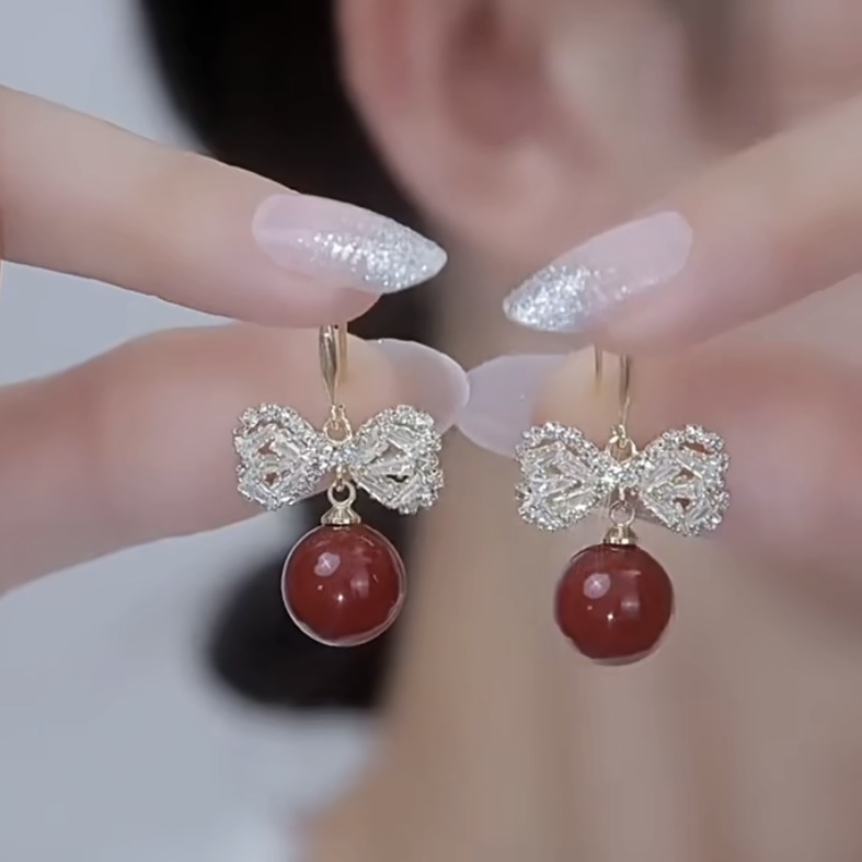 Fashionable red elegant earrings with zircon with bow from pearl