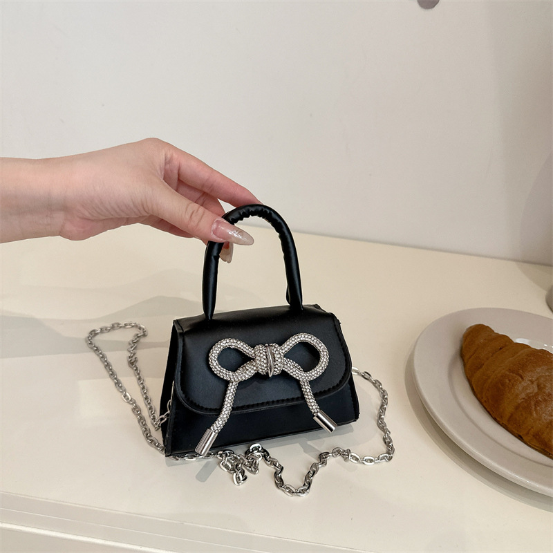 Bowknot Fashion versión coreana de estilo occidental pequeño bolso cuadrado bolso femenino 2025 verano nuevo bolso de cadena de viaje salvaje mujer