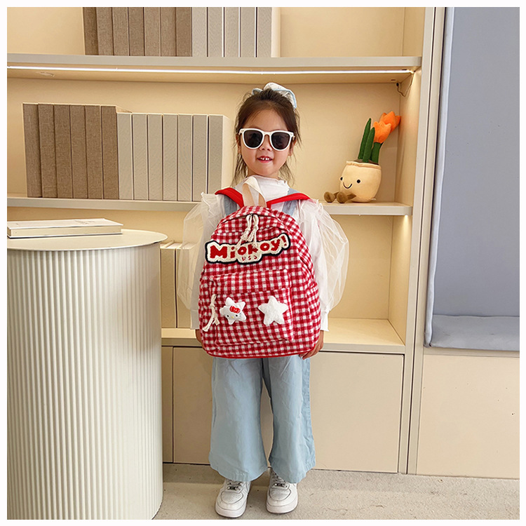 The large-capacity red woolen checkered backpack for primary and secondary school students is a unique and versatile choice. It's a trend for girls to carry backpacks during their leisure trips undefined