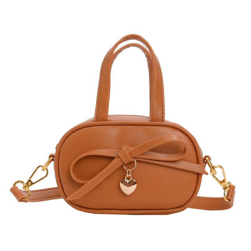 Coreano simple color sólido bolso de hombro para niños y niñas mini bolso de bebé lindo dulce bolso de arco para niños