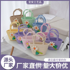 かわいい花の手は綿の糸を持って毛玉のハンドバッグを編みます。