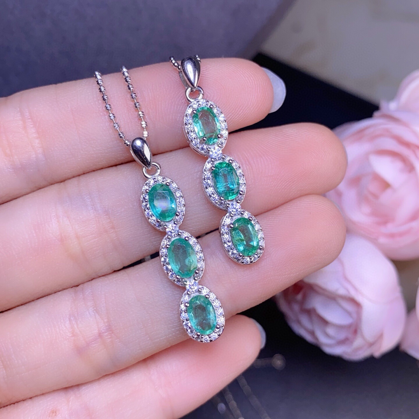 Pure natural Colombian emerald pendants are inlaid with gold