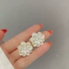 White ear clips, flowered