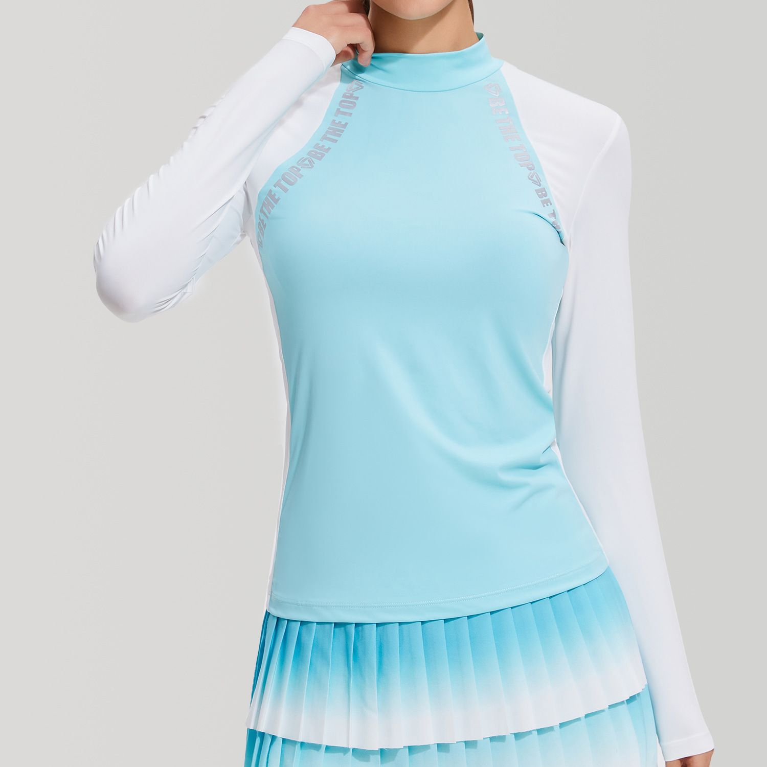 Coloque de medio cuello alto, camiseta de golf de manga larga, delgada, transpirable, curva de corrida de verano, deportes al aire libre de alta elasticidad para mujeres.