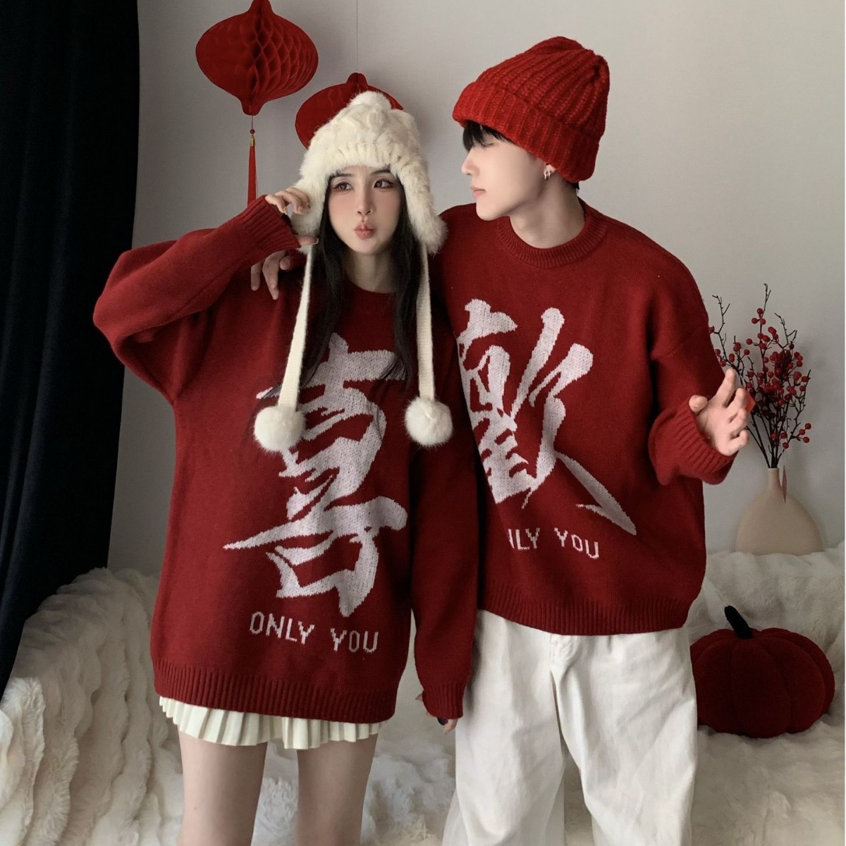 Engagement banquet, marriage registration, couple outfits, red designer sweater, new autumn/winter style, sophisticated and relaxed look.