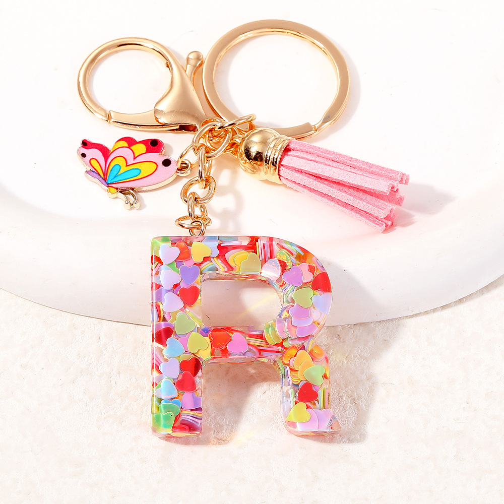 2024 puntos transfronterizos de resina de sequilla rosa 26 letras inglesas llavero colgante mariposa fringe accesorios