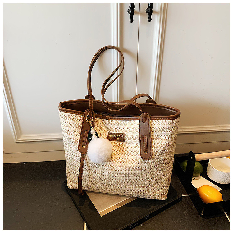 This is a new 2025 summer beach-style women's bag with a simple and versatile hand-held design. It's a single-shoulder vacation woven bag undefined