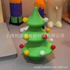 国境を越えて起爆した3Dプリント玩具が踊るクリスマスツリーのデスクトップに小さなおもちゃのクリスマスプレゼントを飾る
