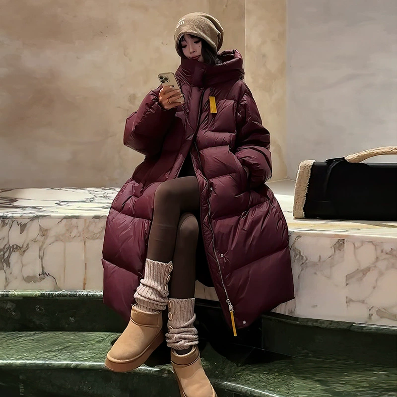 Корейский длинный пуховик для женщин, новинка зимы 2025 года, утепленное пальто с капюшоном и лентами, защита от экстремально низких температур, большие размеры.