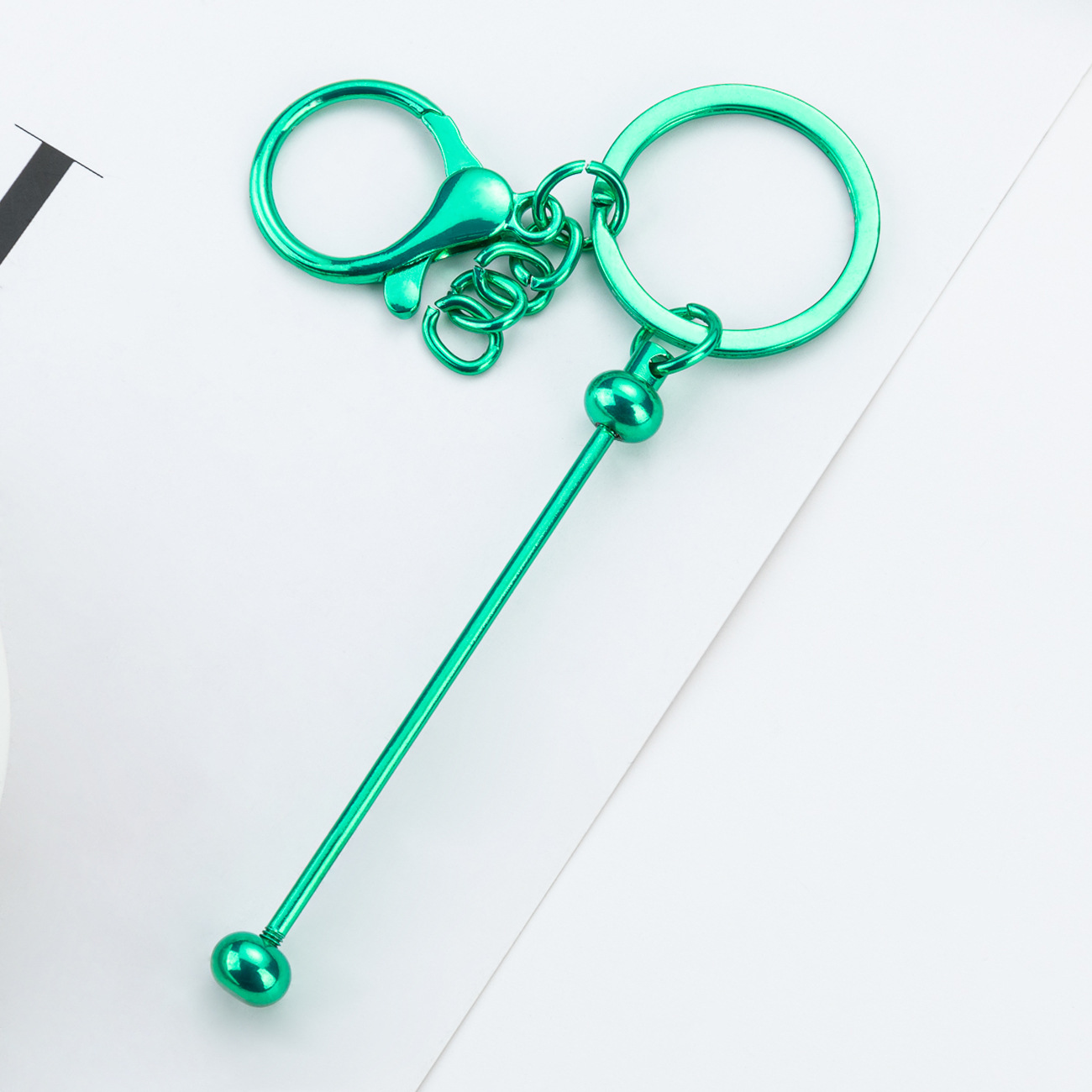 DIY cuentas llaveros auriculares caja de teléfono celular colgante llaveros de metal chapeado UV llaveros al por mayor spot