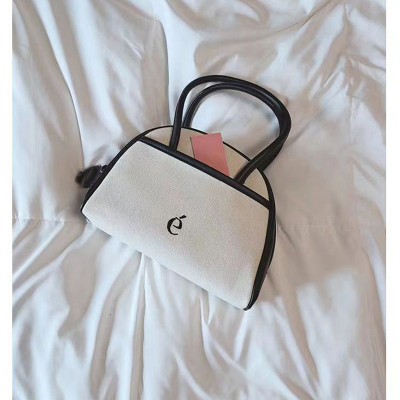 2026 New Korean Designer Niche Half-Moon Boston Color-Block Leather Canvas Handbag Small Tote Bag for Spring and Summer