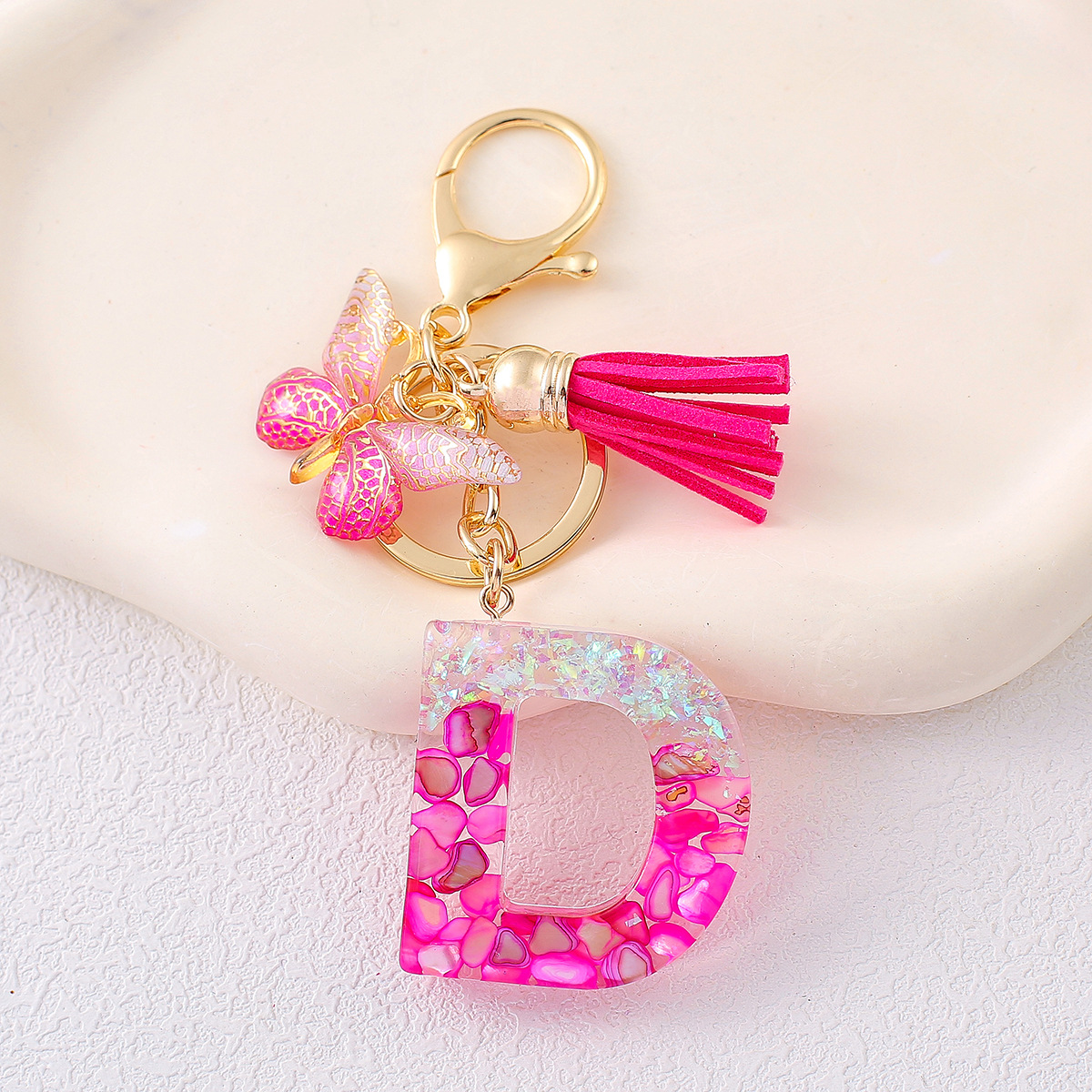 2024 explosión llavero joyería de resina letras bolsos colgantes de dama conchas rojas llavero colgantes de mariposa