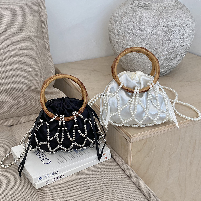 Nueva bolsa china de tejido para niños y niñas bolsas de hombro de perlas de bambú hueco bolsas de mano pequeñas bolsas de cuerda de dibujo para niños