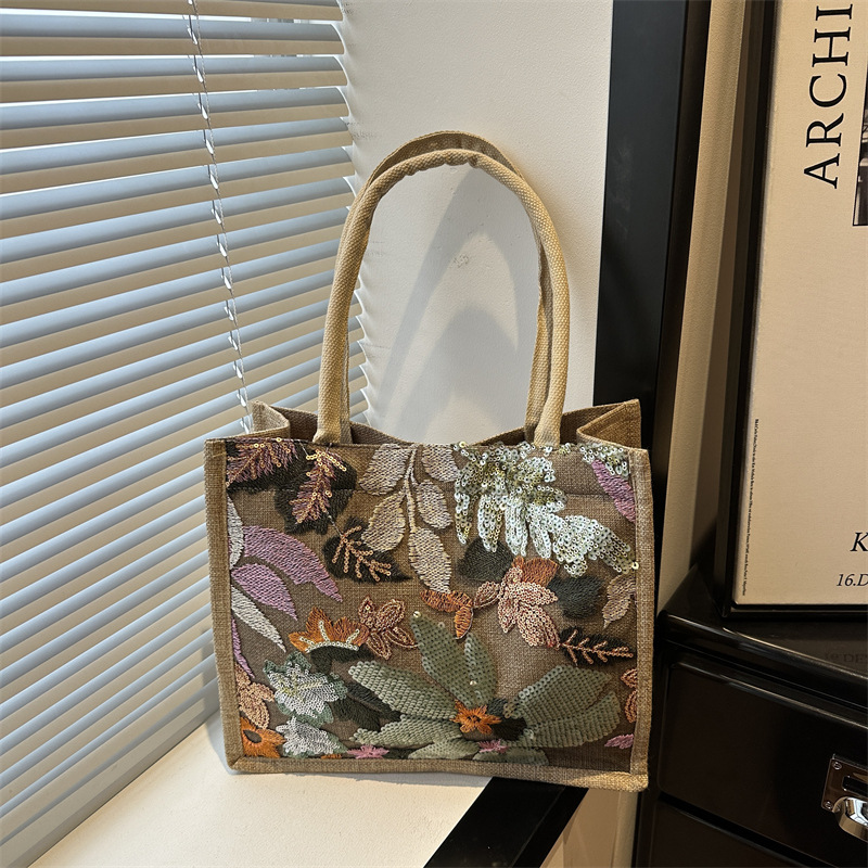 Explosiones transfronterizas 2026 textura de lino de alta calidad, flores bordadas, bolsas de tendencia horizontales, bolsas de compras de aire exterior