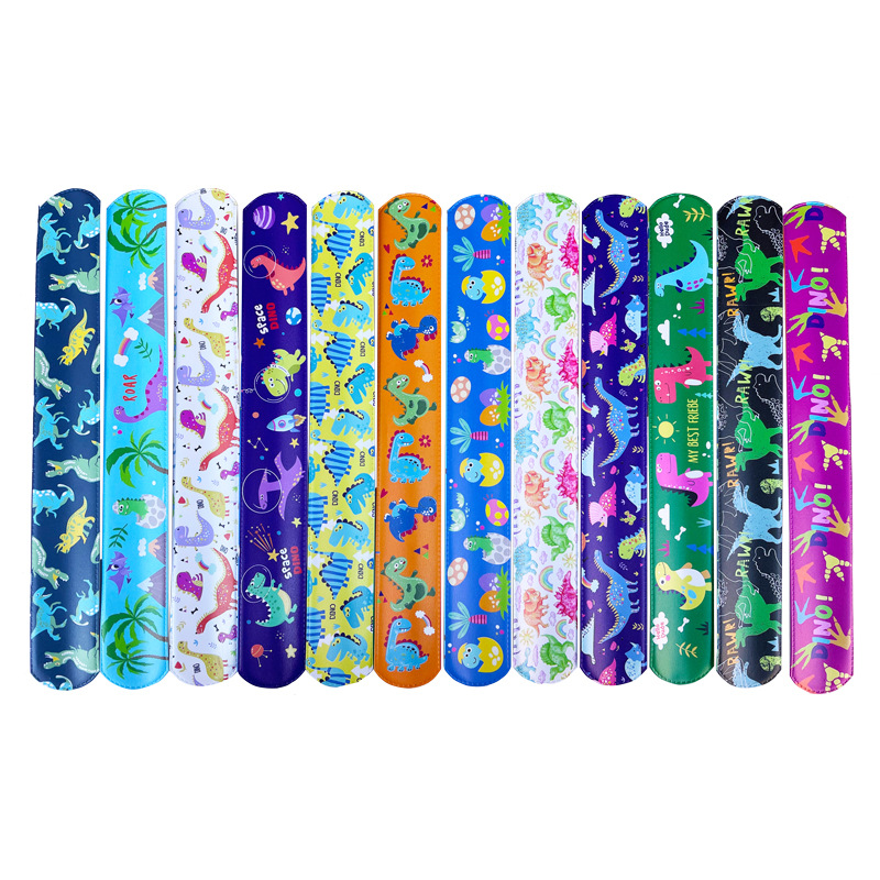 Nuevo mundo jurásico dinosaurio Snap anillo retro dinosaurio huevo huellas partido PVC raqueta anillo pulsera de los niños