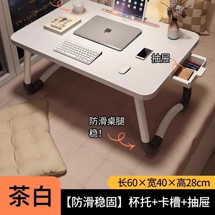 折り畳み可能なベッドの上の小さなテーブルは机のノートパソコンのテーブルを勉強します。|undefined