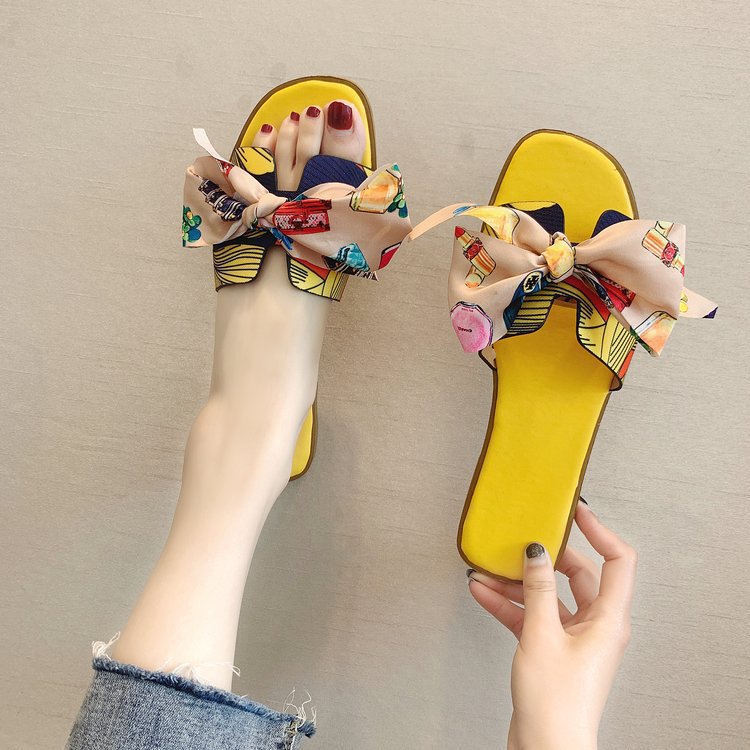 Cintas de colores zapatillas de arco de talón plano de verano para mujeres nuevas zapatillas de flores al por mayor