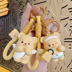 漫画のバターの熊の子供の鍵は精巧な女子学生の包みを掛けて自動車の鍵のチェーンの子供機の小さい贈り物を包みます。